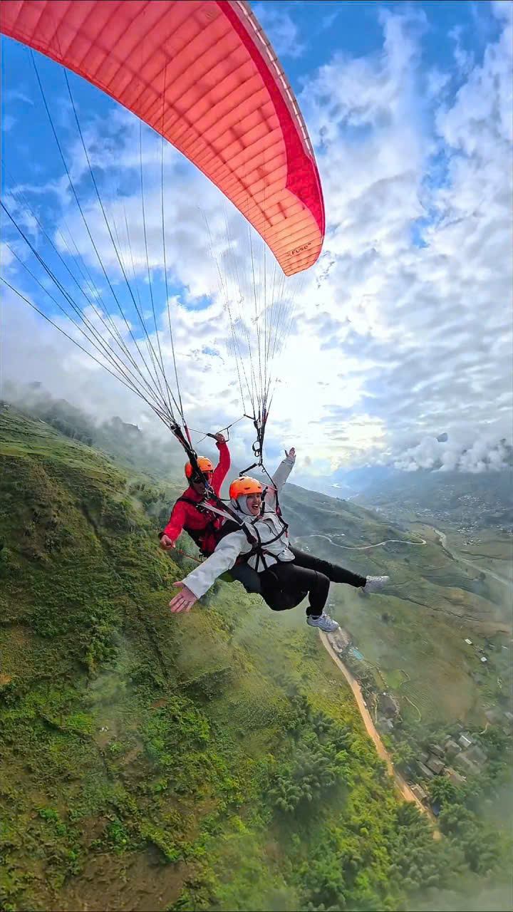 Tandem paragliding above the mountains near Sa Pa