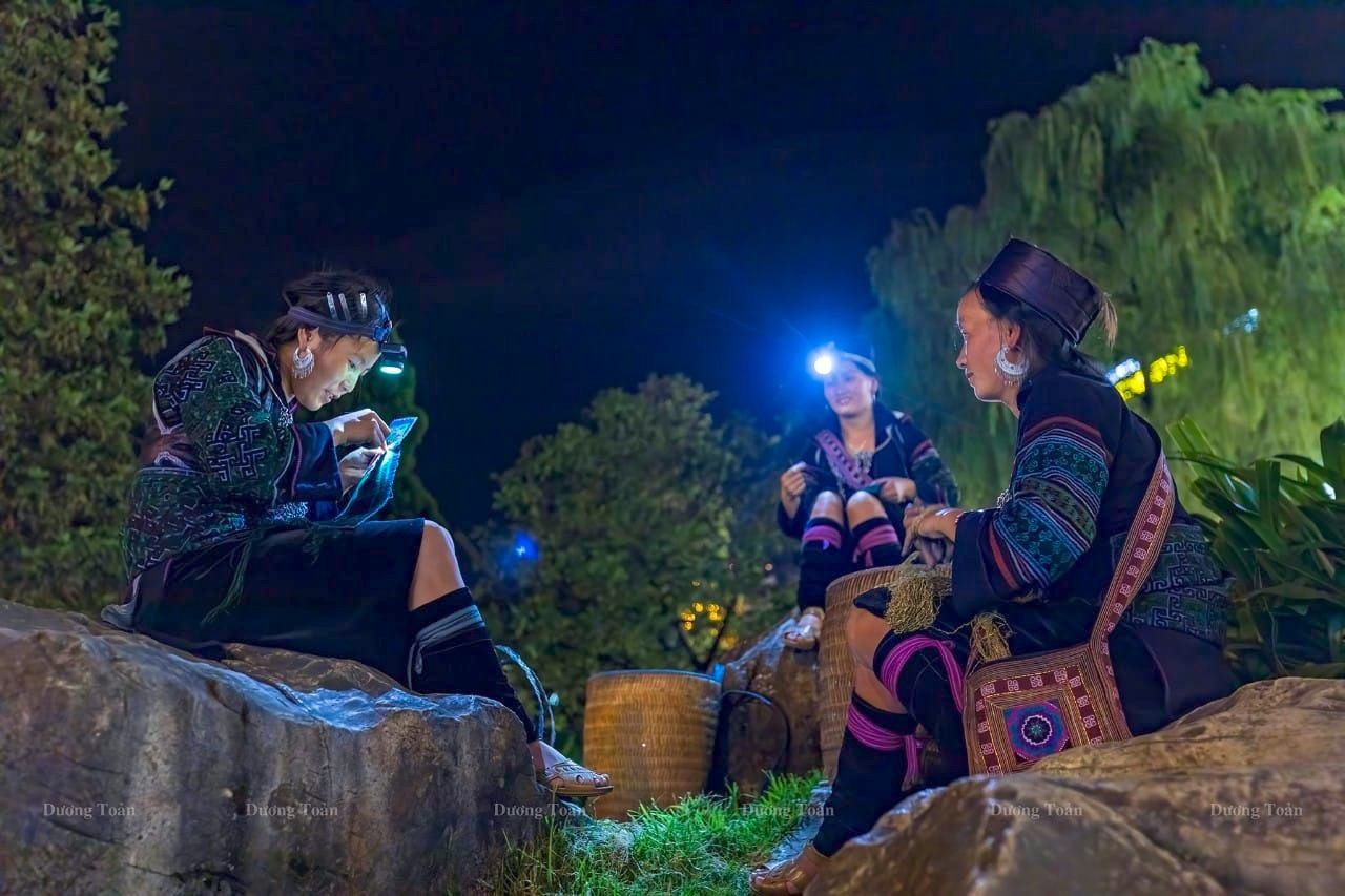 Local women talking together outdoors at night