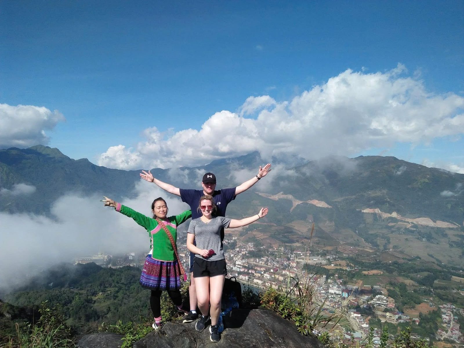 Guide and guests at a panoramic viewpoint above Sa Pa