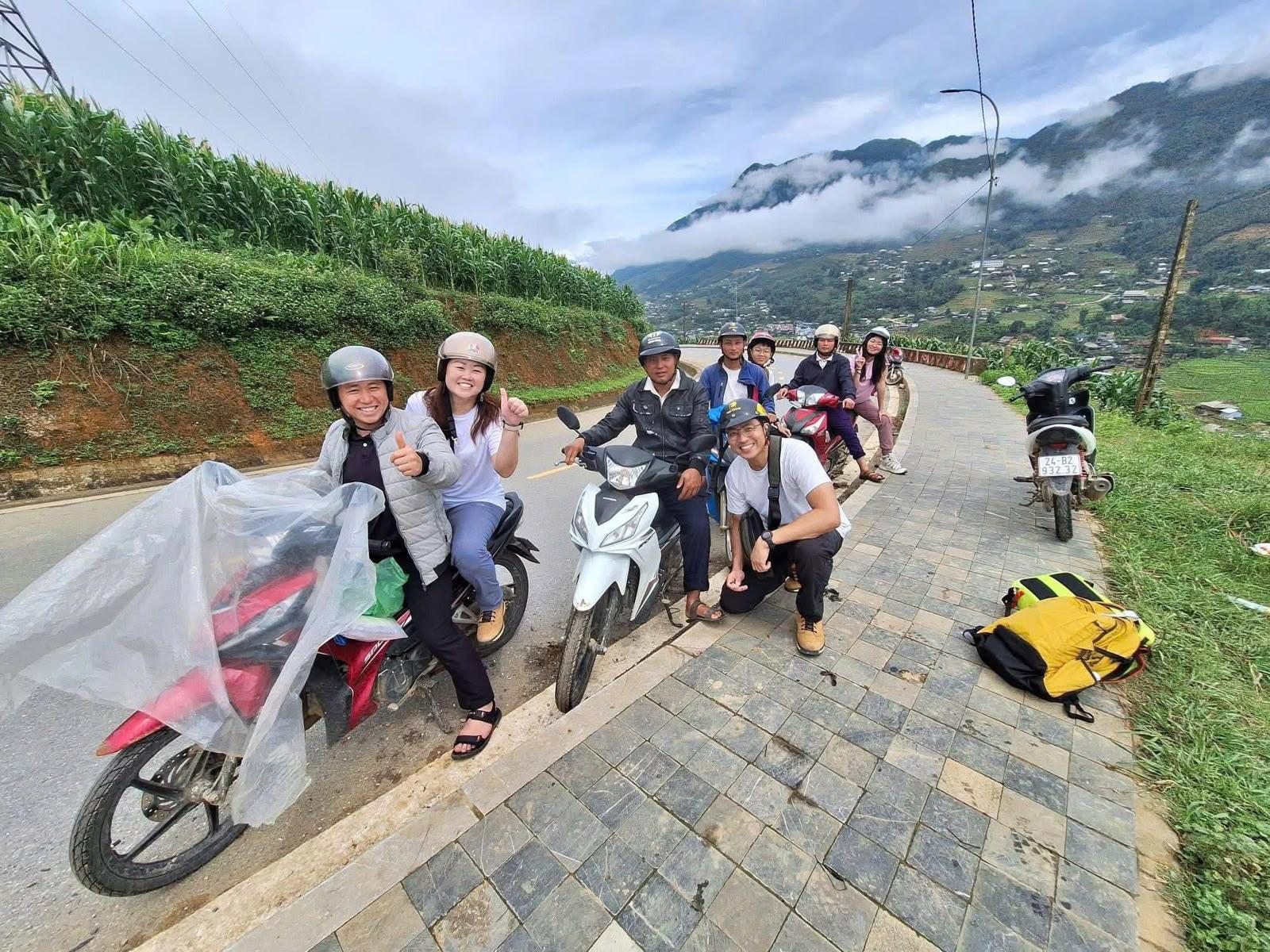 Guides and guests with motorbikes and raincoats in the mountains