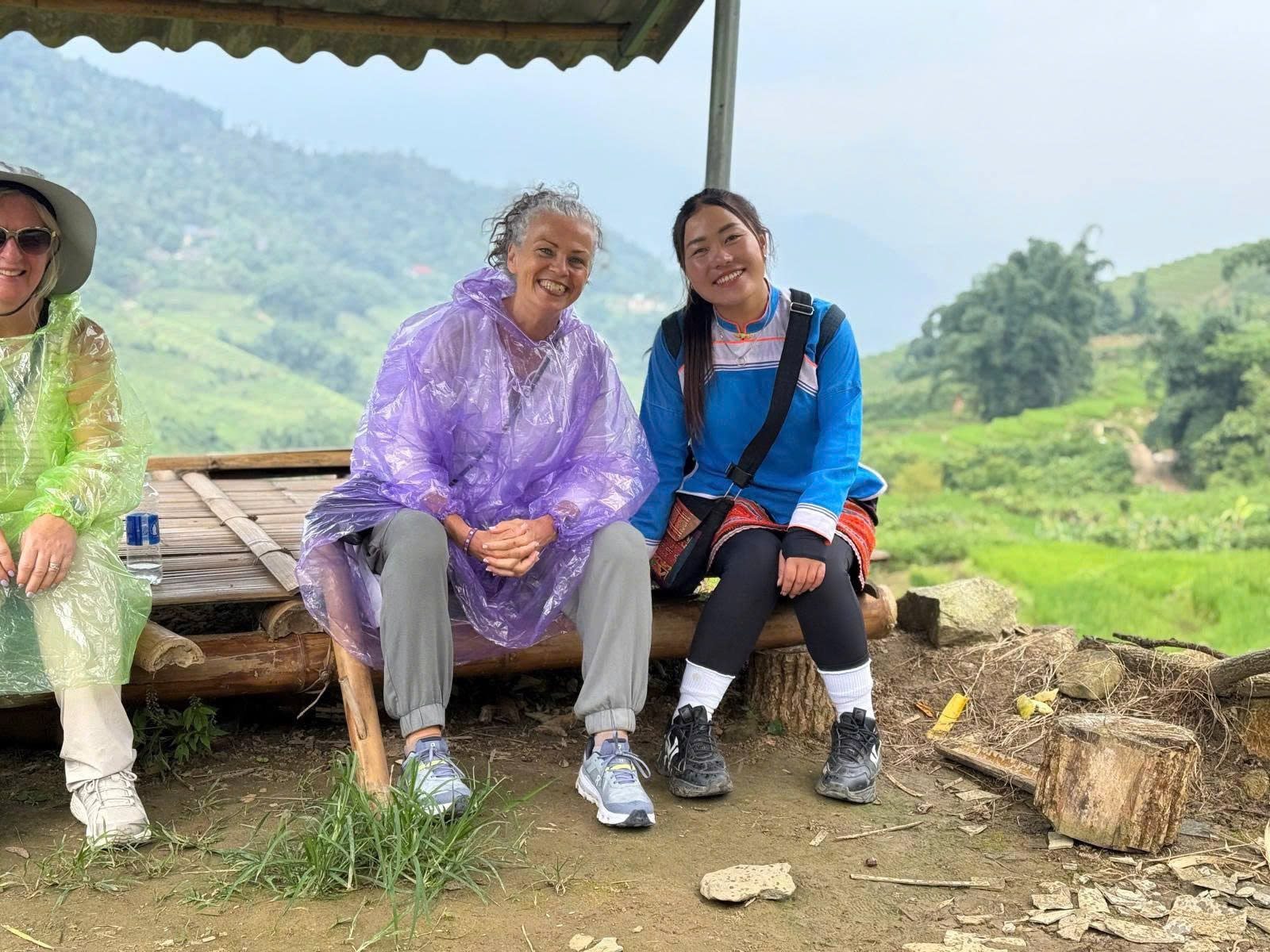 Nhu sitting with guests during a trek near Sa Pa
